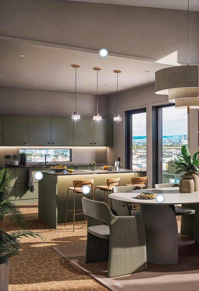 Modern kitchen with green cabinetry, pendant lights, and a dining area.